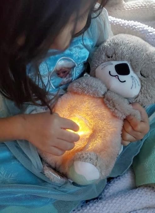 Child hugging the sleep otter
